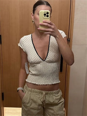Women's white V-neck printed short sleeve top.