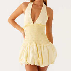 Yellow halter dress with smocked bodice and ruffled skirt- front