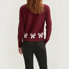Maroon sweater with white bow designs - back view