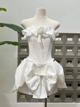 White dress on a mannequin against a neutral background