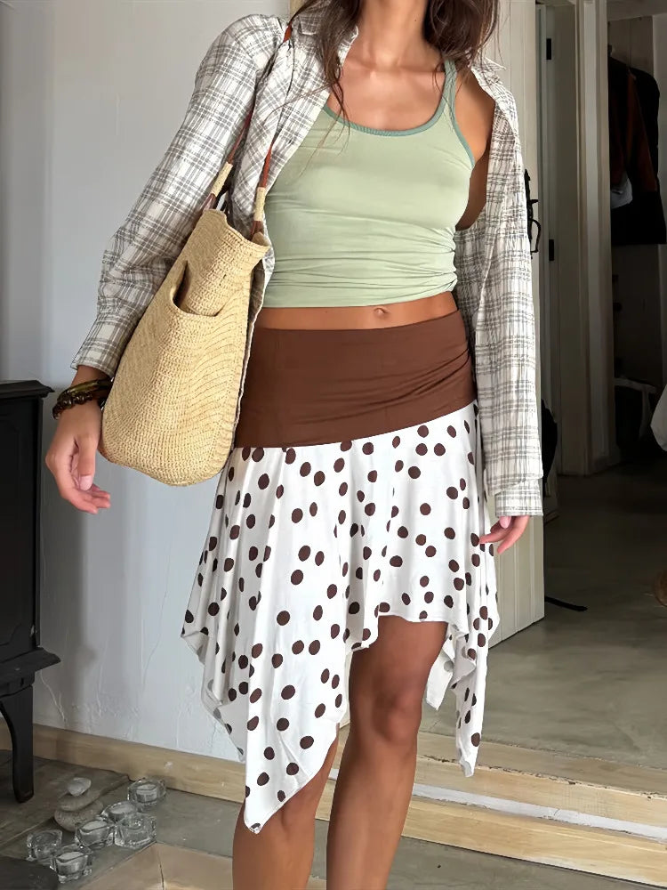 Women's polka dot low rise irregular short skirt with A-line silhouette.