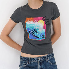 Person wearing a dark gray t-shirt with a colorful graphic design