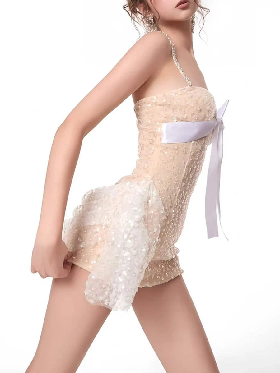 Model wearing a mini dress with a flattering A-line silhouette and sparkling strap details.