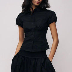 Women's polka dot button down lapel top with puff sleeves.