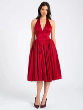 Red halter-neck dress worn by a model on a white background
