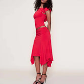Red dress with cut-out design worn by a model on a plain background