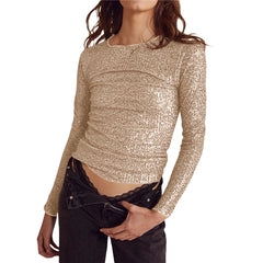 Woman wearing a sparkly gold long-sleeve top