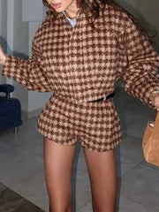Person wearing a brown and beige checkered outfit indoors.