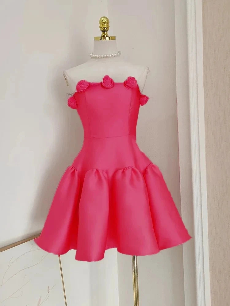 Pink dress on a mannequin against a neutral wall
