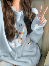 Person wearing a light blue sweater with cartoon designs, sitting in a car.