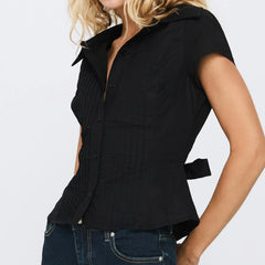 Black sleeveless shirt worn by a person - side, belted