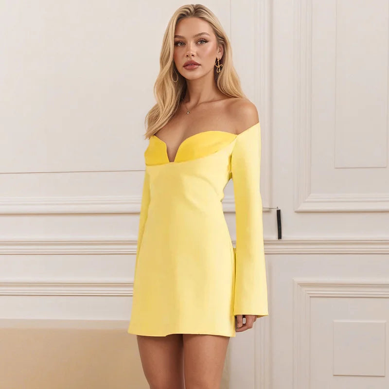 Woman wearing a yellow dress against a white wall.