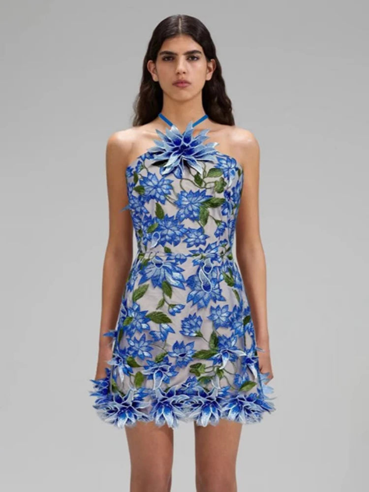 Woman wearing a blue floral dress on a gray background