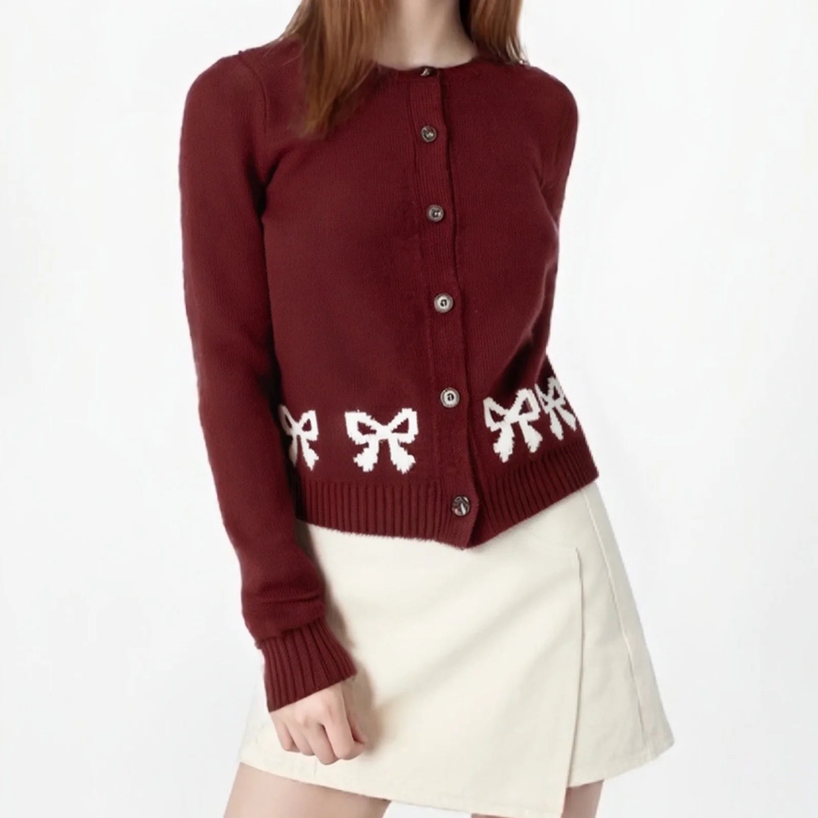 Red cardigan with white bow patterns worn by a person