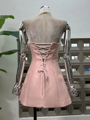 Pink corset dress on a mannequin against a neutral background