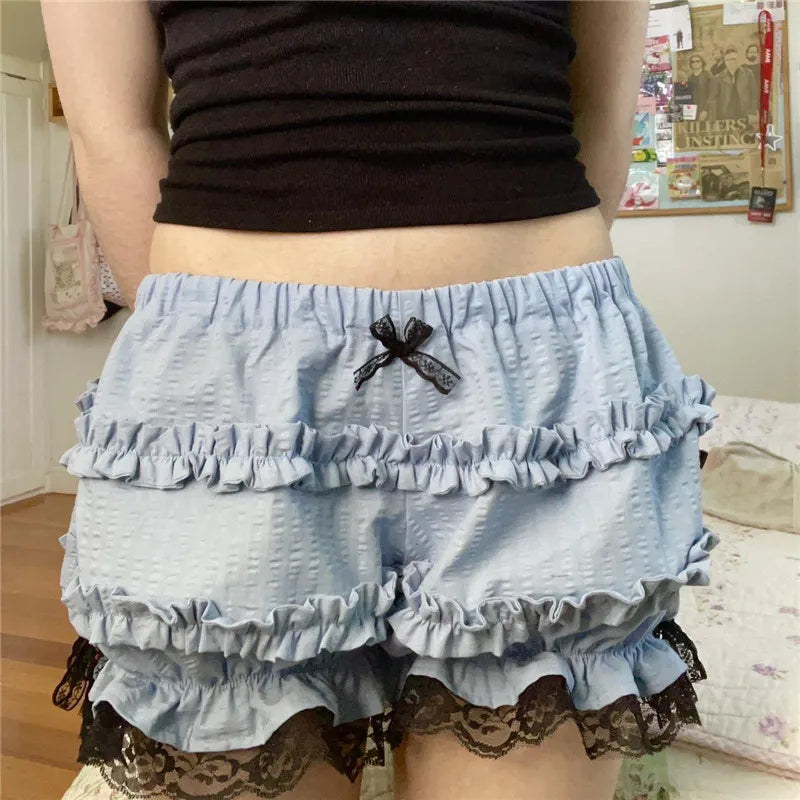 Light blue ruffled shorts with lace details worn by a person indoors.