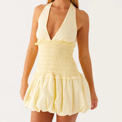 Yellow halter dress with smocked bodice and ruffled skirt