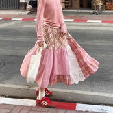 Women's plaid patchwork midi skirt with lace decoration and A-line silhouette.