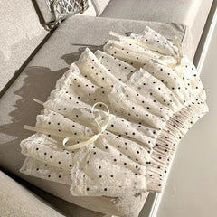 Women's white polka dots elastic mini skirt with a bow.