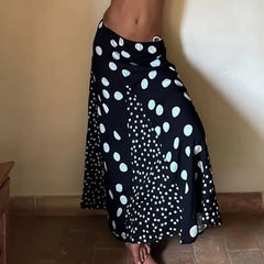 Black skirt with white polka dot pattern on a plain background