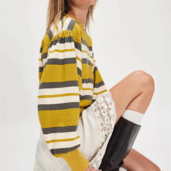 Woman wearing a striped dress with a white background