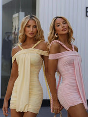 Two women wearing off-shoulder dresses standing side by side.
