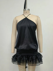 Women's black halter open back mini dress with a vintage sheath style.