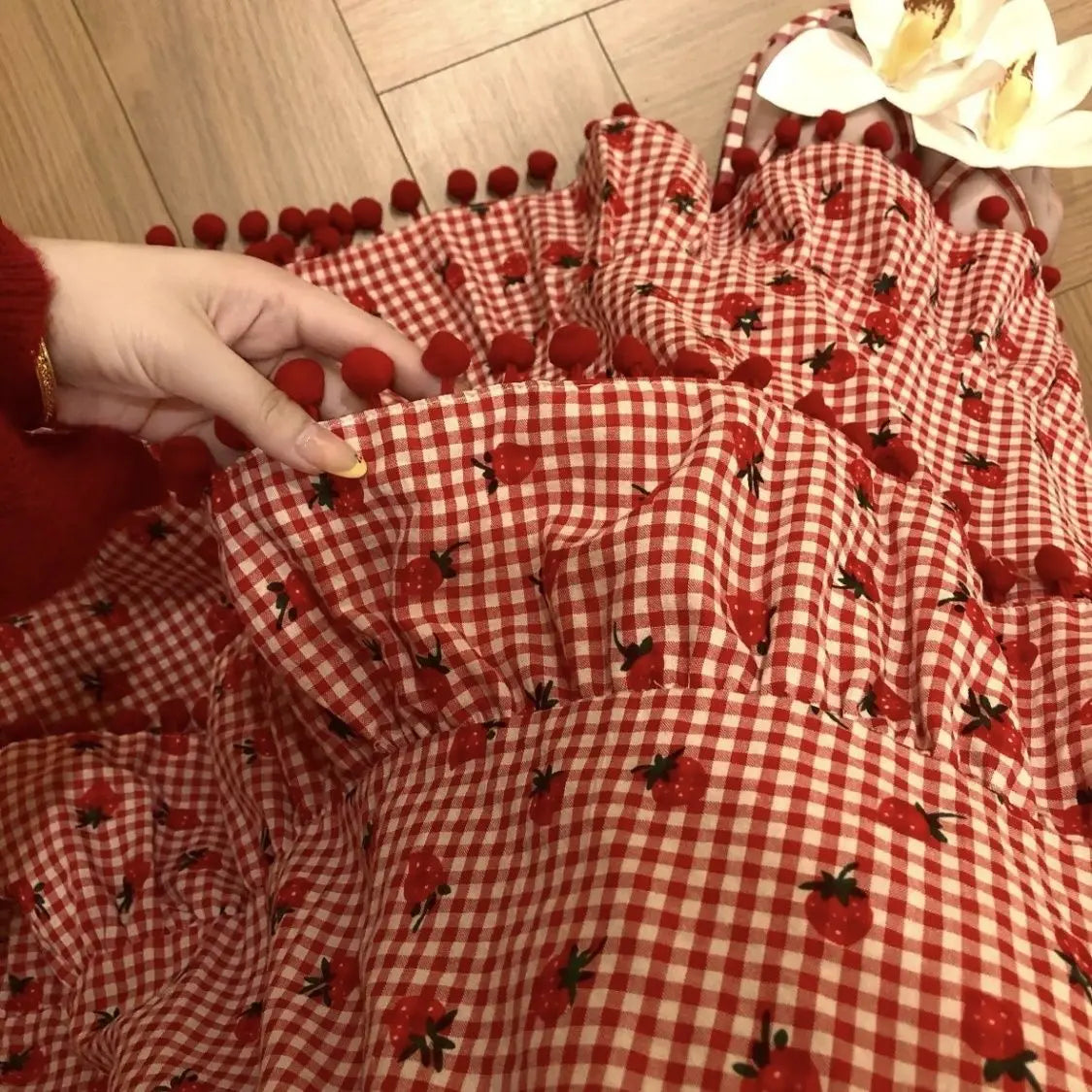 Women's red strawberry print tassel long skirt with tiered ruffles.