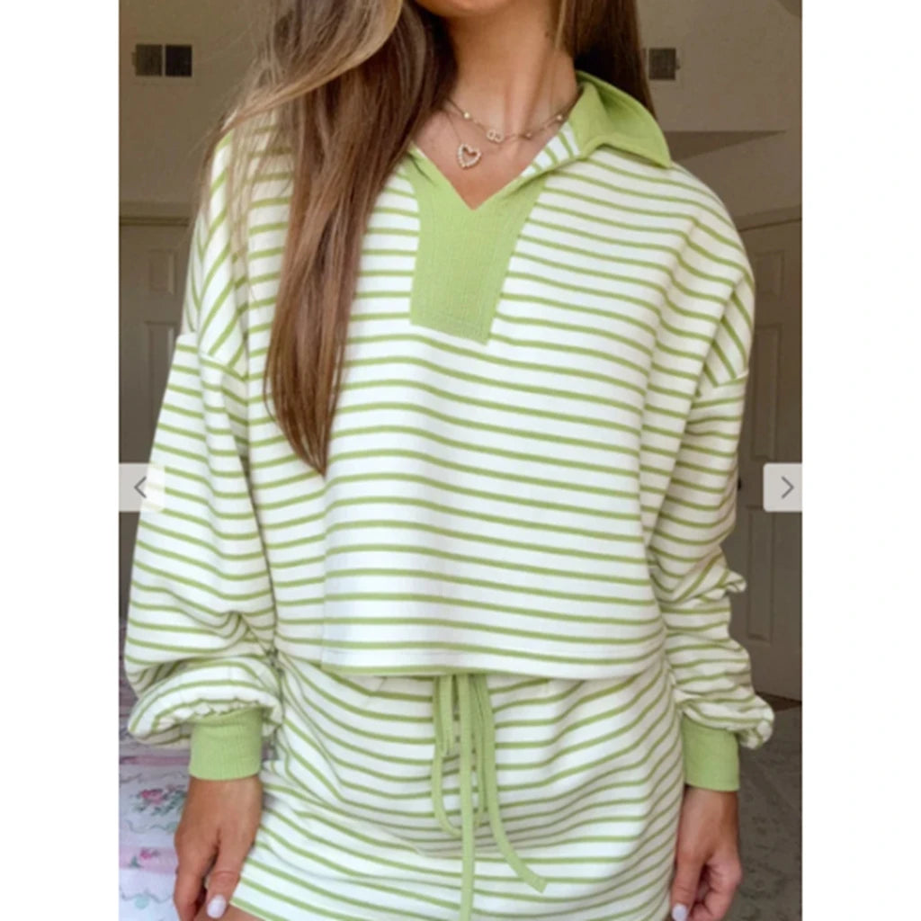 Green and white striped loungewear set worn by a person indoors.