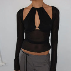 Black long-sleeve top with cut-out design worn by a person on a plain background