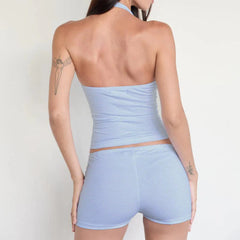 Woman wearing a light blue strapless top and shorts set -back