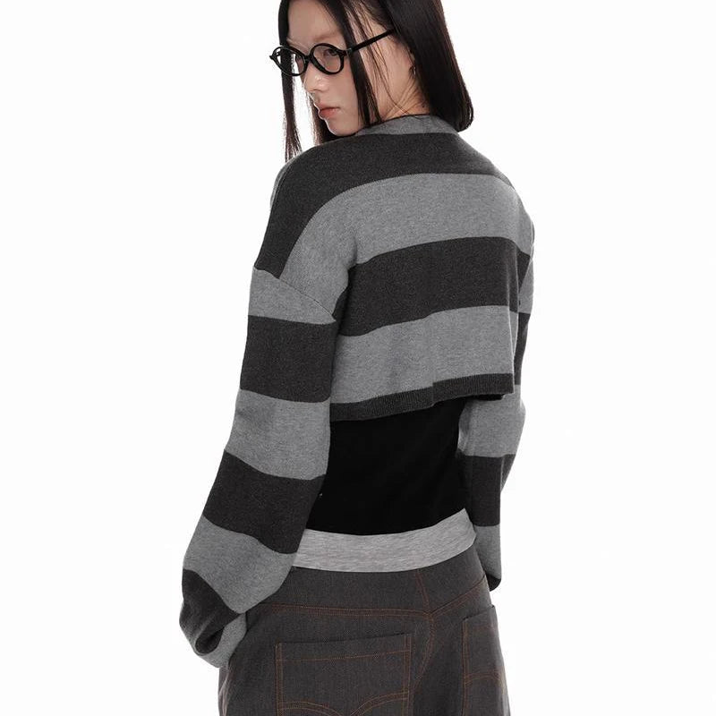 Person wearing a black and gray striped sweater