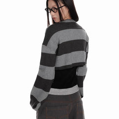 Person wearing a black and gray striped sweater