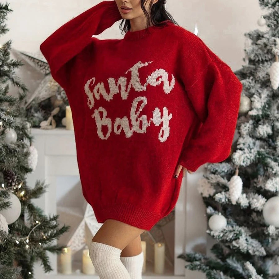Person wearing a red sweater with 'Santa Baby' text in a festive setting with Christmas trees.