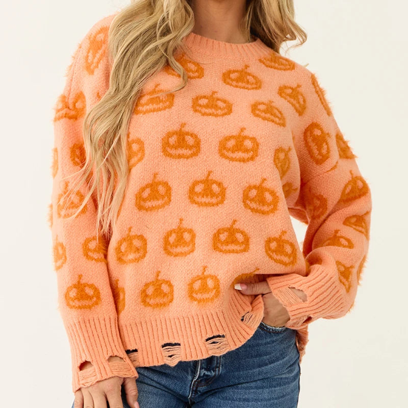 Person wearing an orange sweater with pumpkin patterns