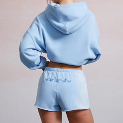 Light blue hoodie and shorts set on a plain background