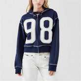 Navy blue hoodie with large white numbers '98' worn by a person