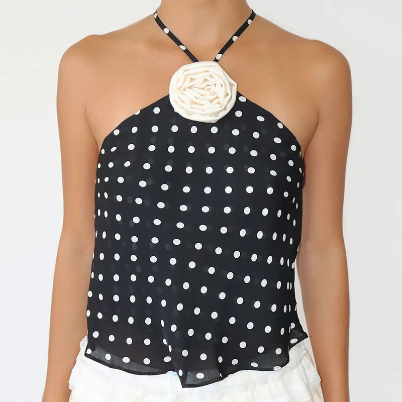 Black polka dot halter top with a white flower accessory