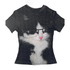 A short-sleeve crewneck t-shirt in dark charcoal gray, featuring a large graphic print of a black and white cat wearing black-rimmed glasses.