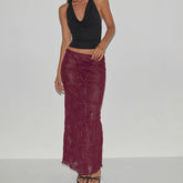 Woman wearing a black top and burgundy lace skirt- full view