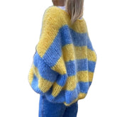 Yellow and blue striped sweater on a white background