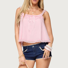 Woman wearing a pink top and denim shorts - front