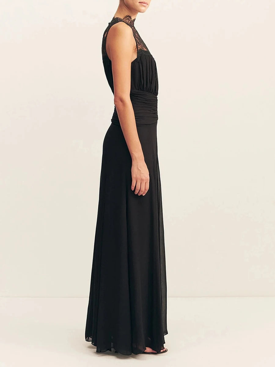 Black evening gown with lace detailing on a white background