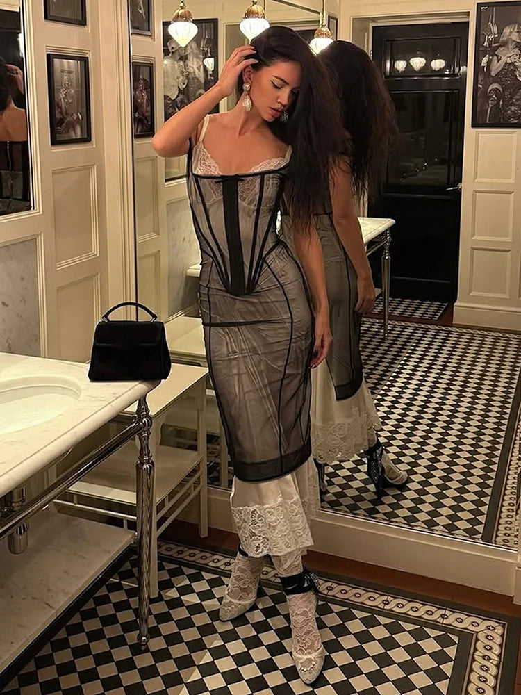 Woman in a stylish outfit standing in a room with checkered floor and mirror.