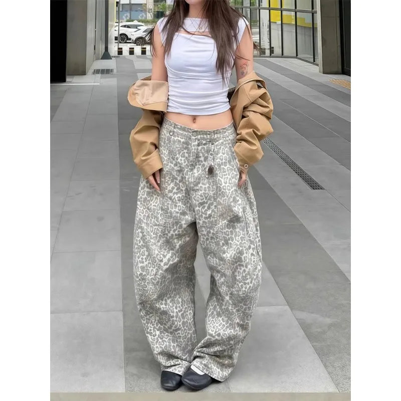 Person wearing a white crop top and patterned pants in an urban setting
