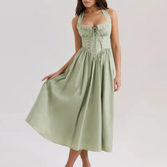 Women's green embroidered halter midi dress with A-line silhouette.