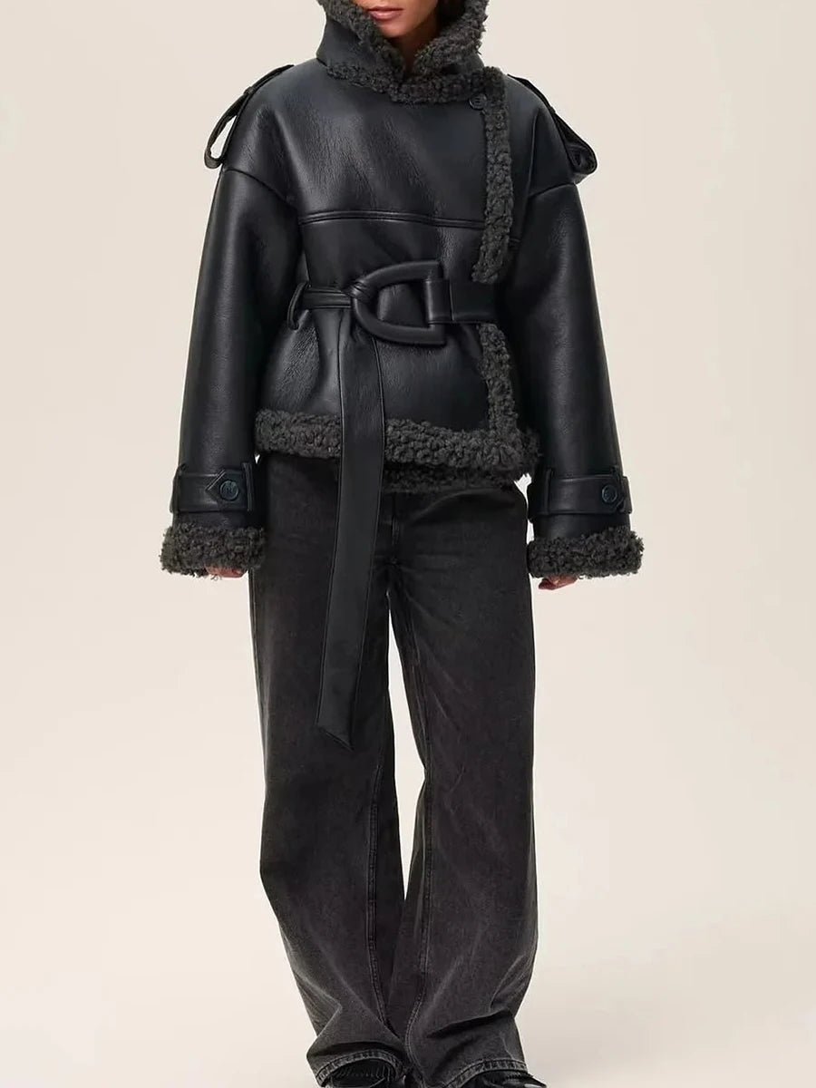Black leather outfit with fur trim on a beige background