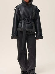 Black leather outfit with fur trim on a beige background