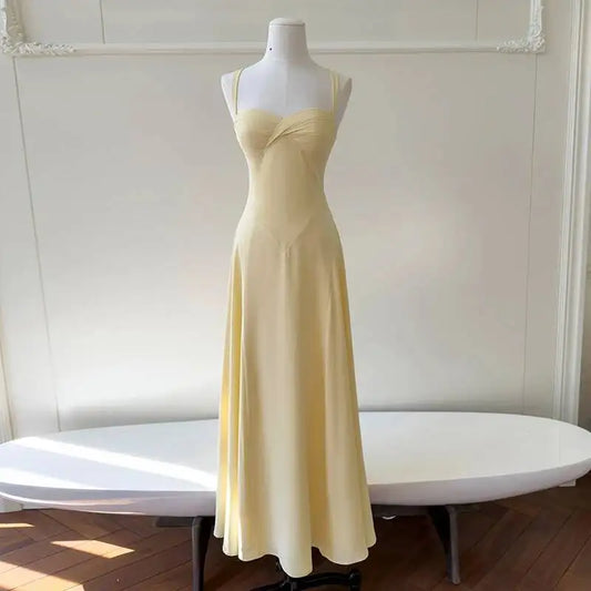 Pale yellow maxi dress with sweetheart neckline and spaghetti straps, shown from the front.