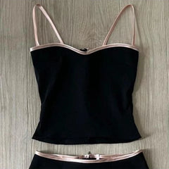 Black camisole with thin straps on a wooden surface